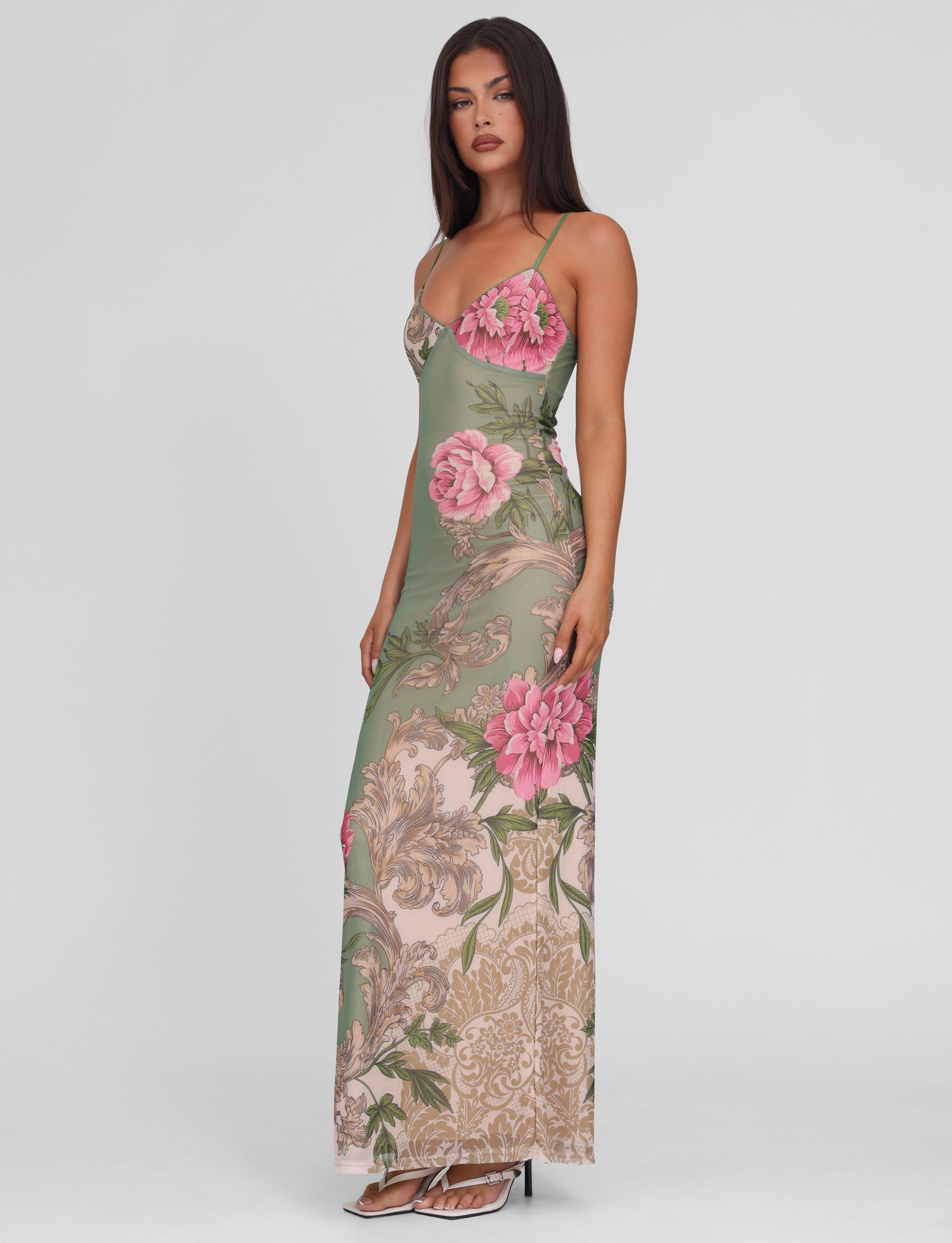 Side view of sage green maxi dress with pink roses and baroque scroll details