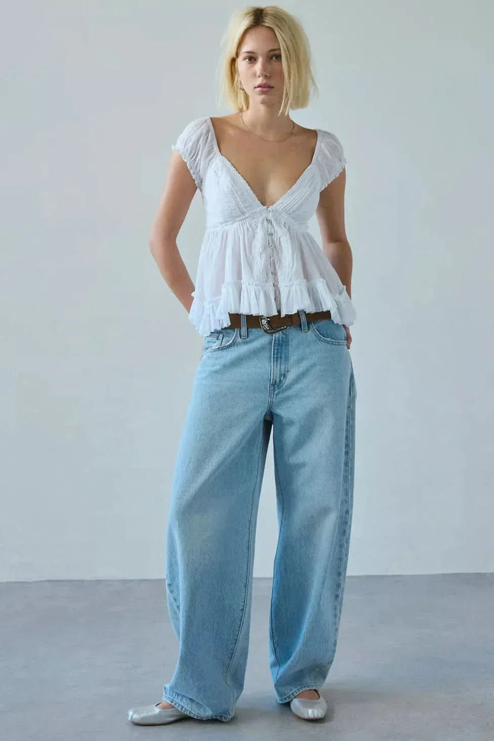 White lace v-neck blouse with puff sleeves and tiered ruffle hem for women
