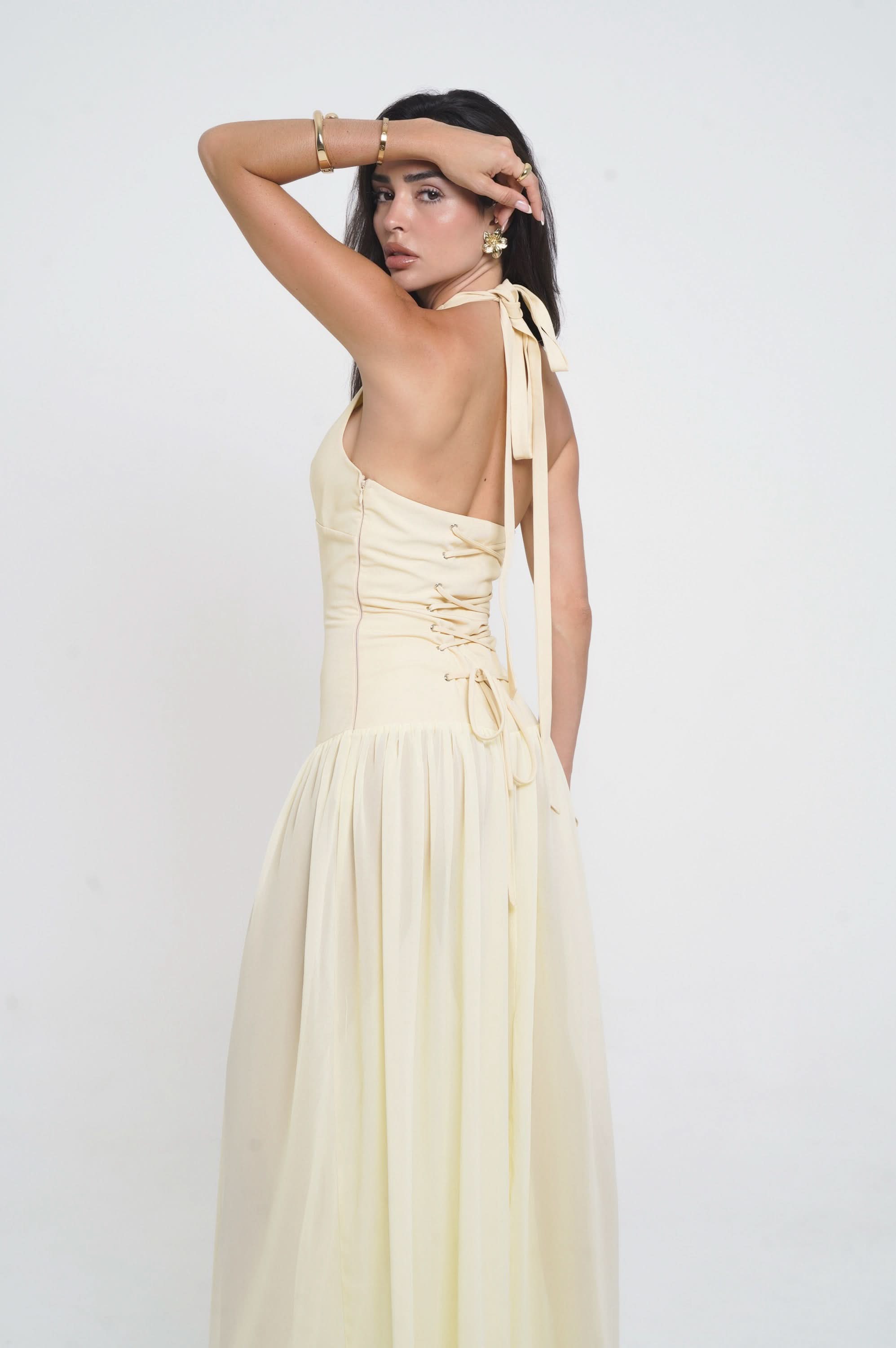 Back view of cream halter dress with lace-up starfish detail and open back
