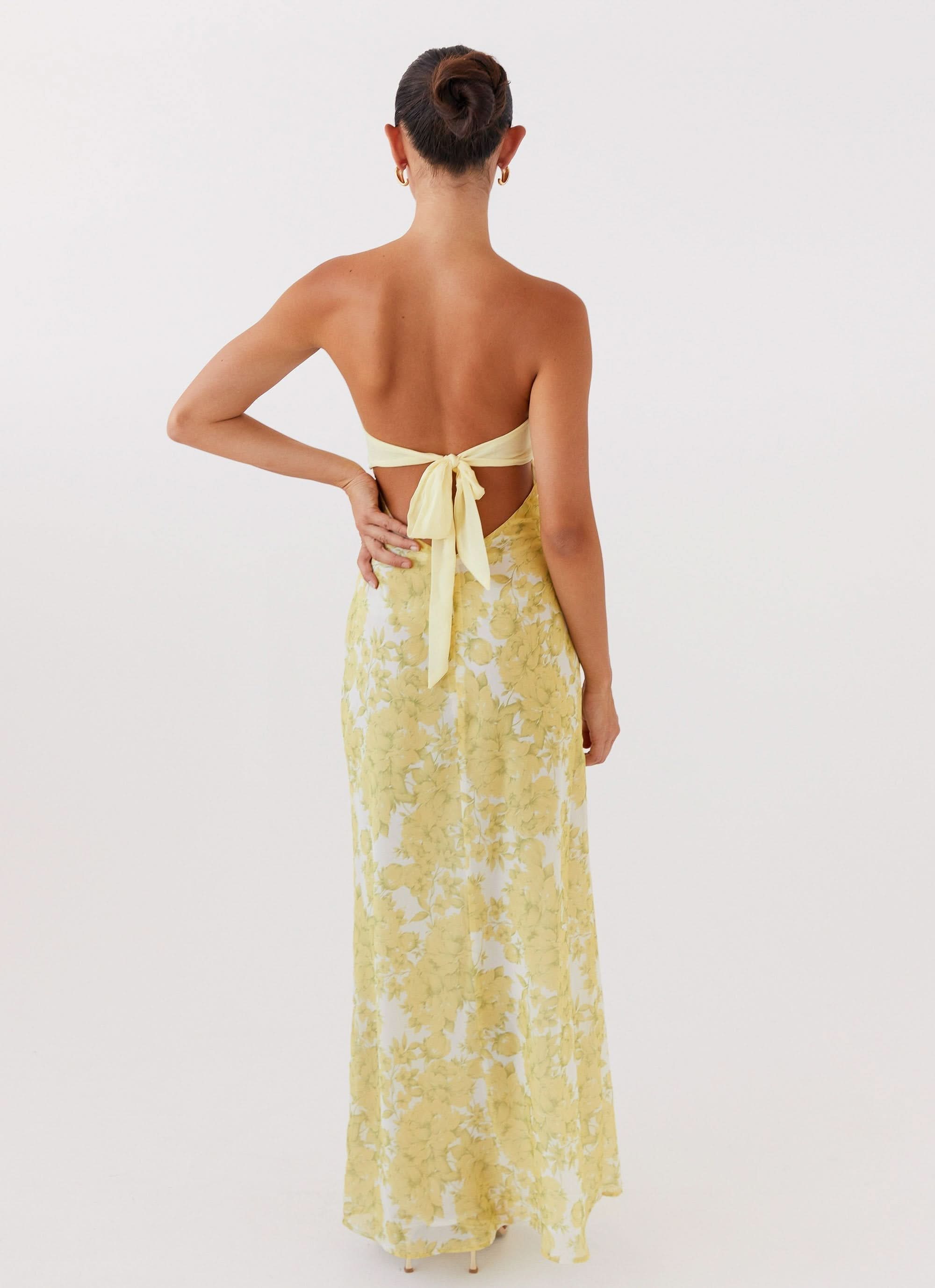 Back view of yellow floral maxi dress with tie closure