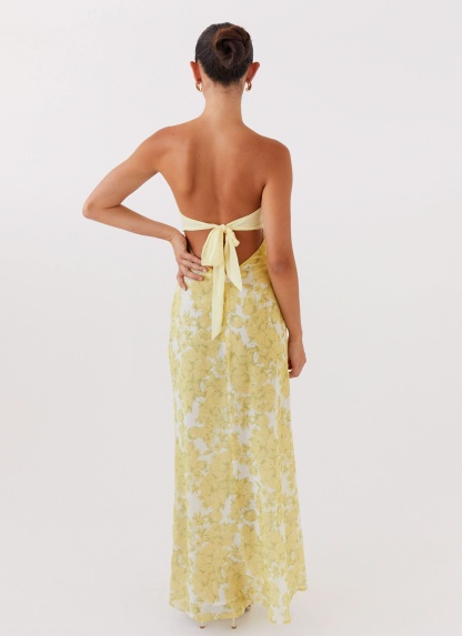 Back view of yellow floral maxi dress with tie closure