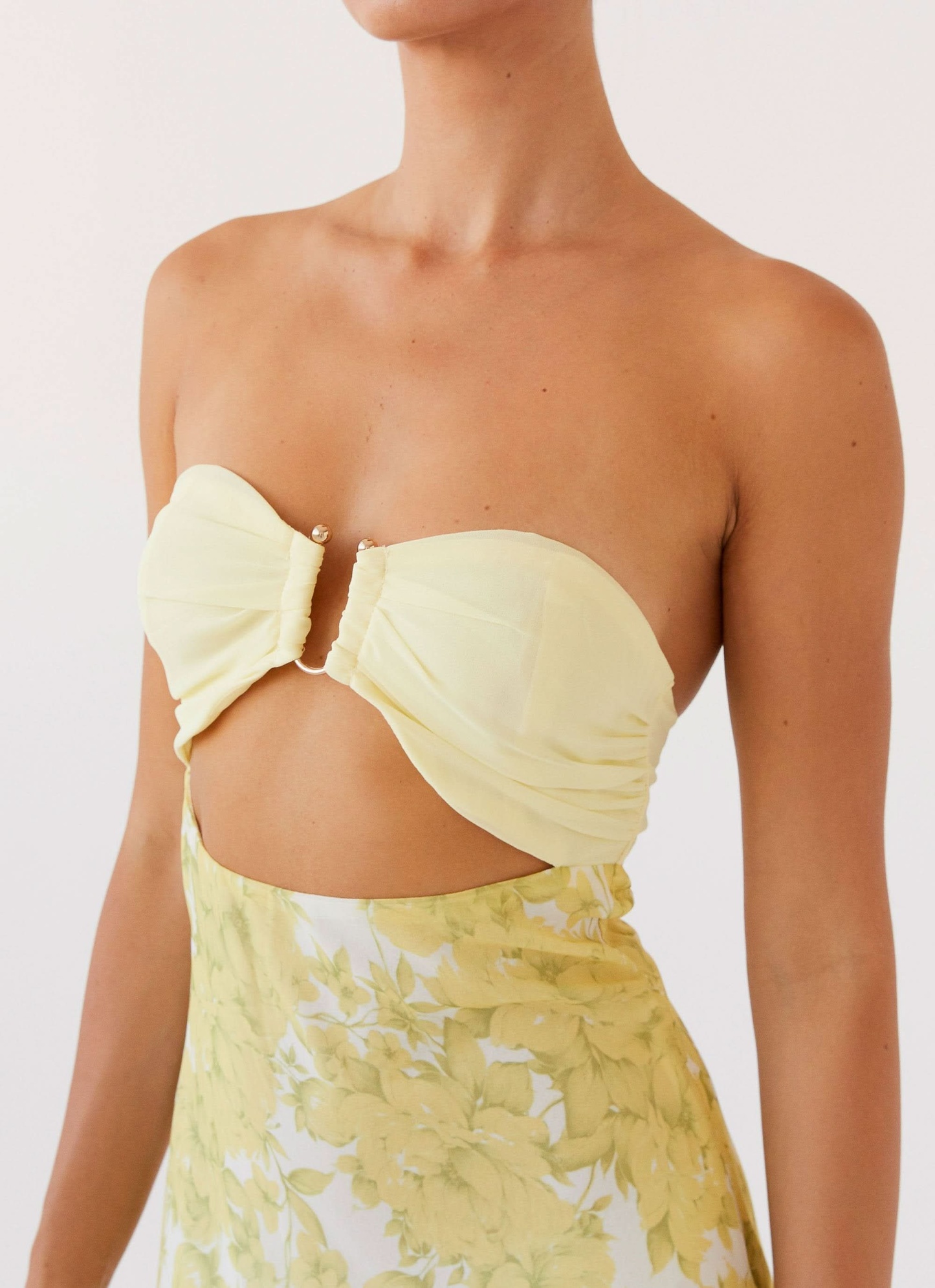 Close-up of yellow strapless cutout maxi dress bodice