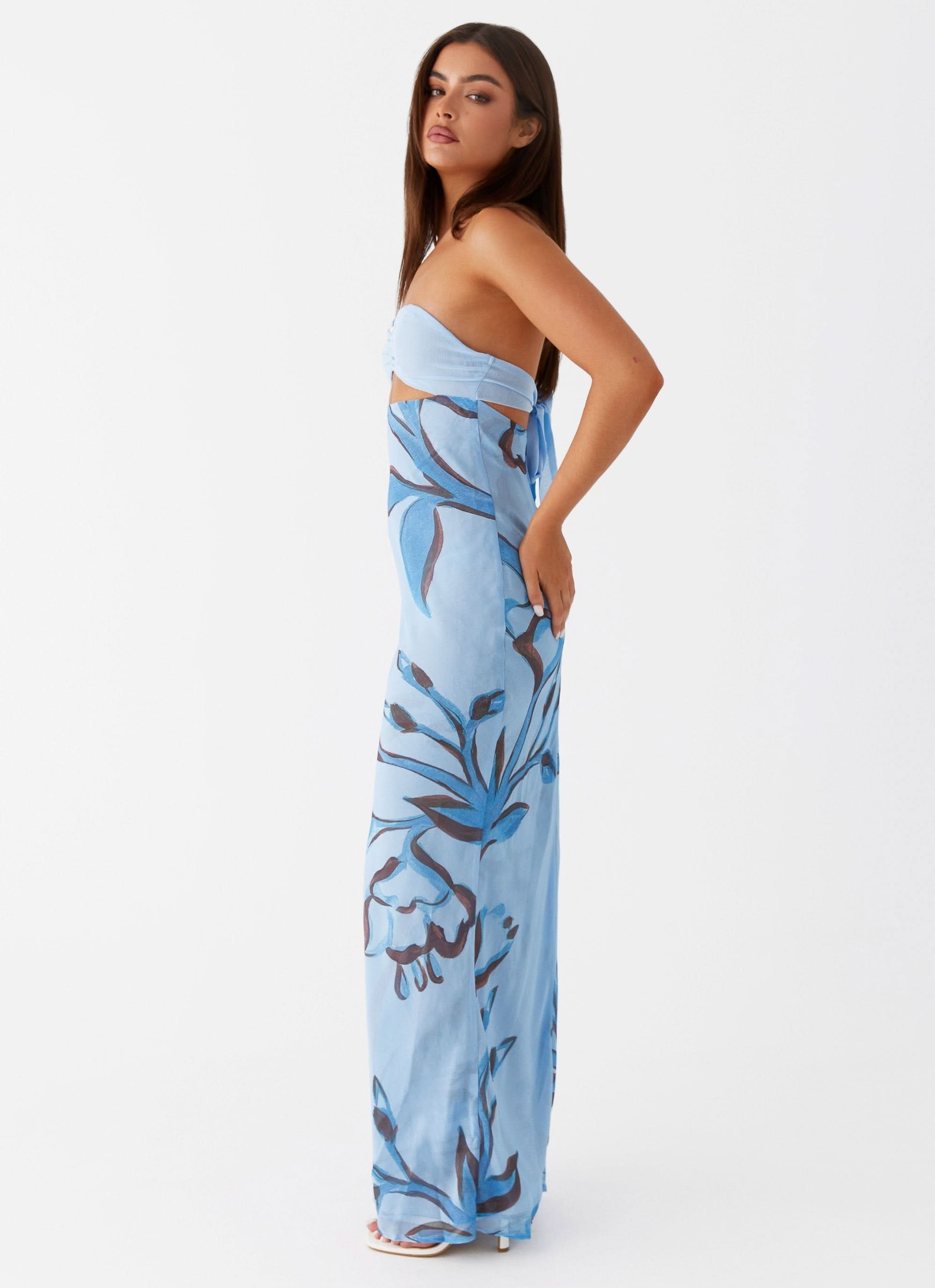 Side view of blue floral cutout maxi dress with waist detail