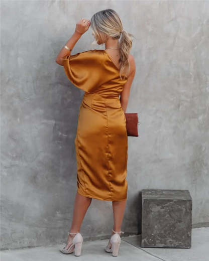 Black one-shoulder draped midi dress on street with asymmetrical neckline