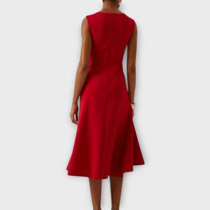 Back view of red draped midi dress with flowing skirt