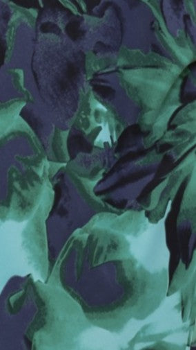 Navy and mint abstract leaf pattern fabric close-up texture