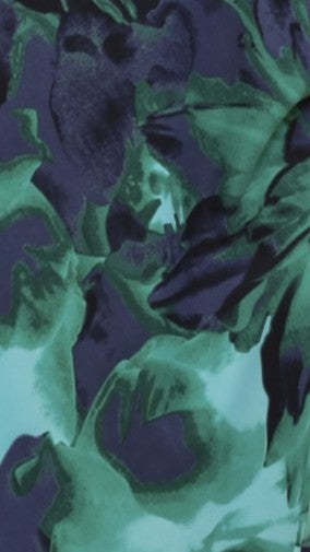 Navy and mint abstract leaf pattern fabric close-up texture