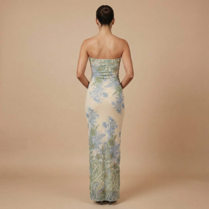 Back view of strapless maxi dress with blue botanical print and ruffled asymmetrical hem