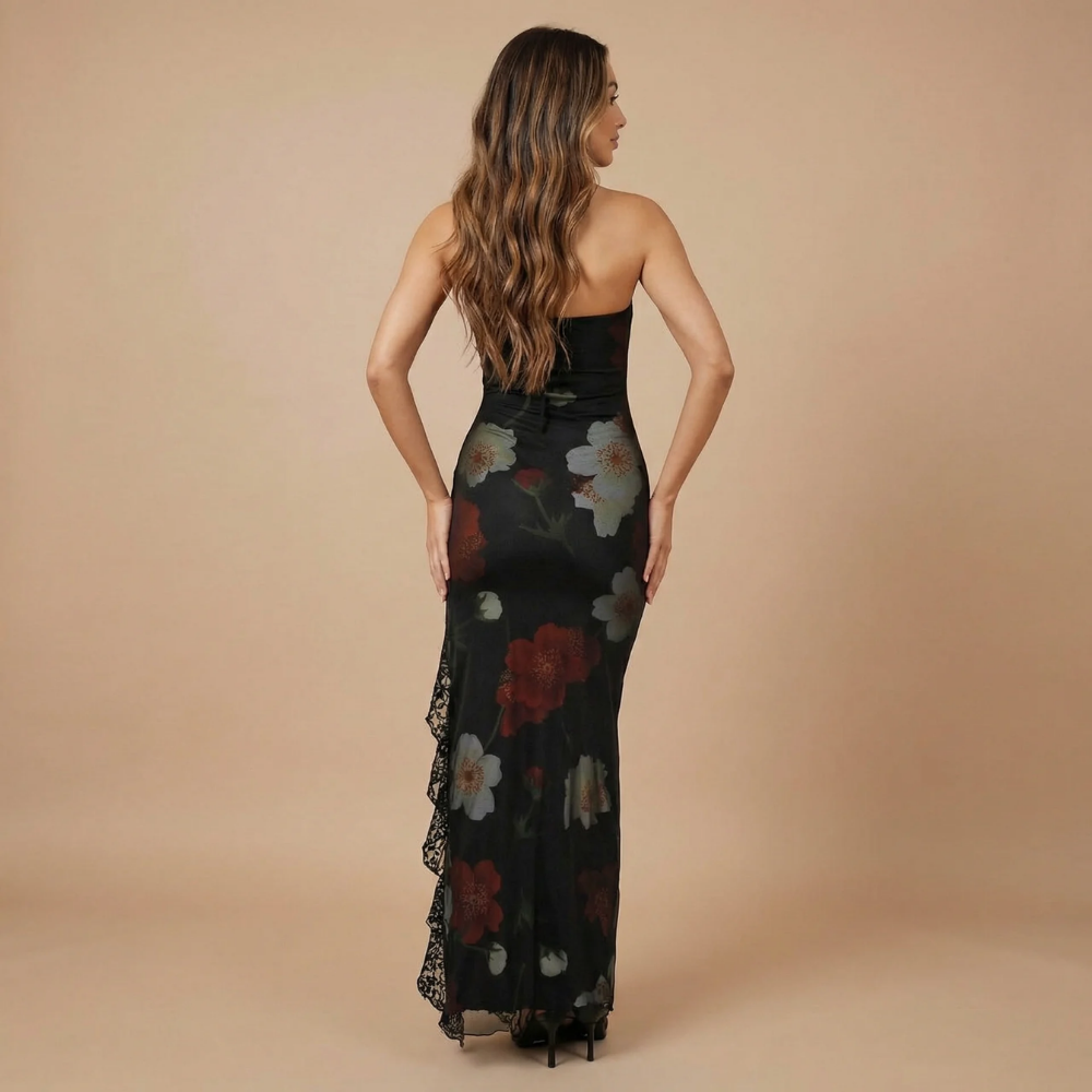 Back view of black maxi dress with white red flowers and lace ruffle detail on side