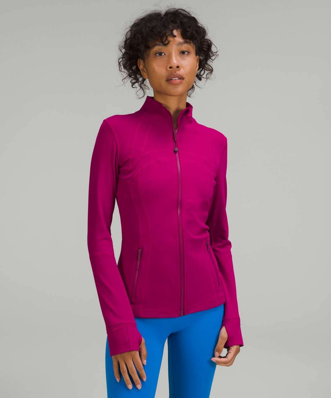 Magenta contoured zip jacket with curved seams and fitted waist