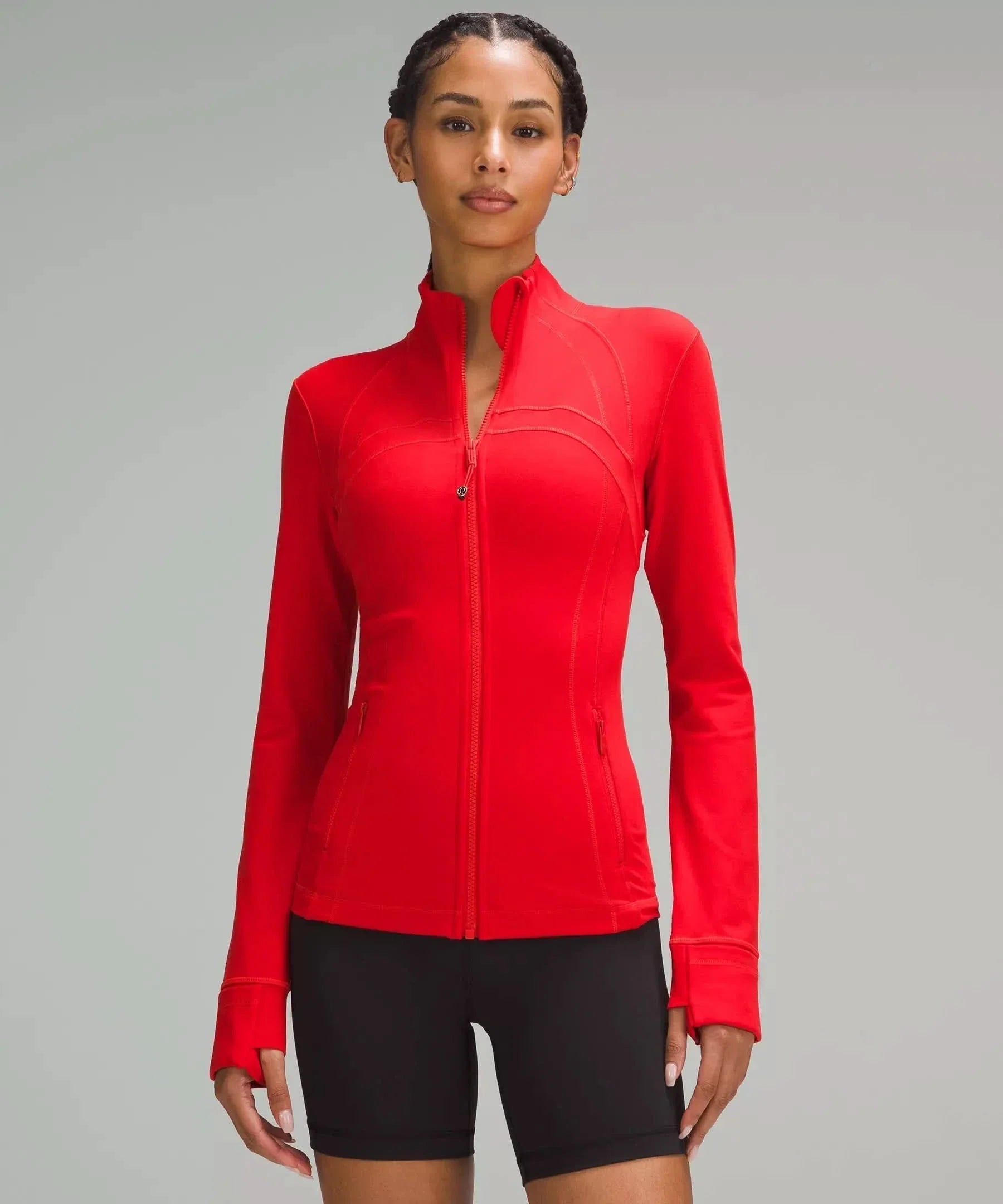 Red contoured zip jacket with curved body-hugging seams and cuffs