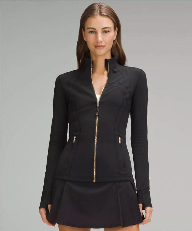 Black contoured zip jacket with gold hardware and fitted waist design