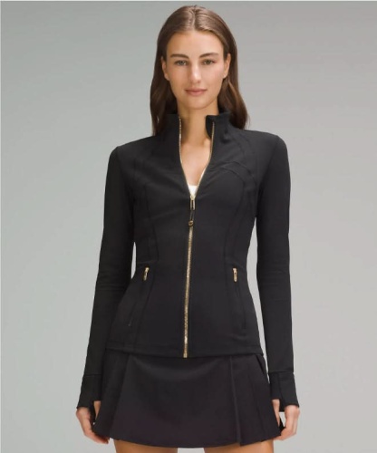 Black contoured zip jacket with gold hardware and fitted waist design