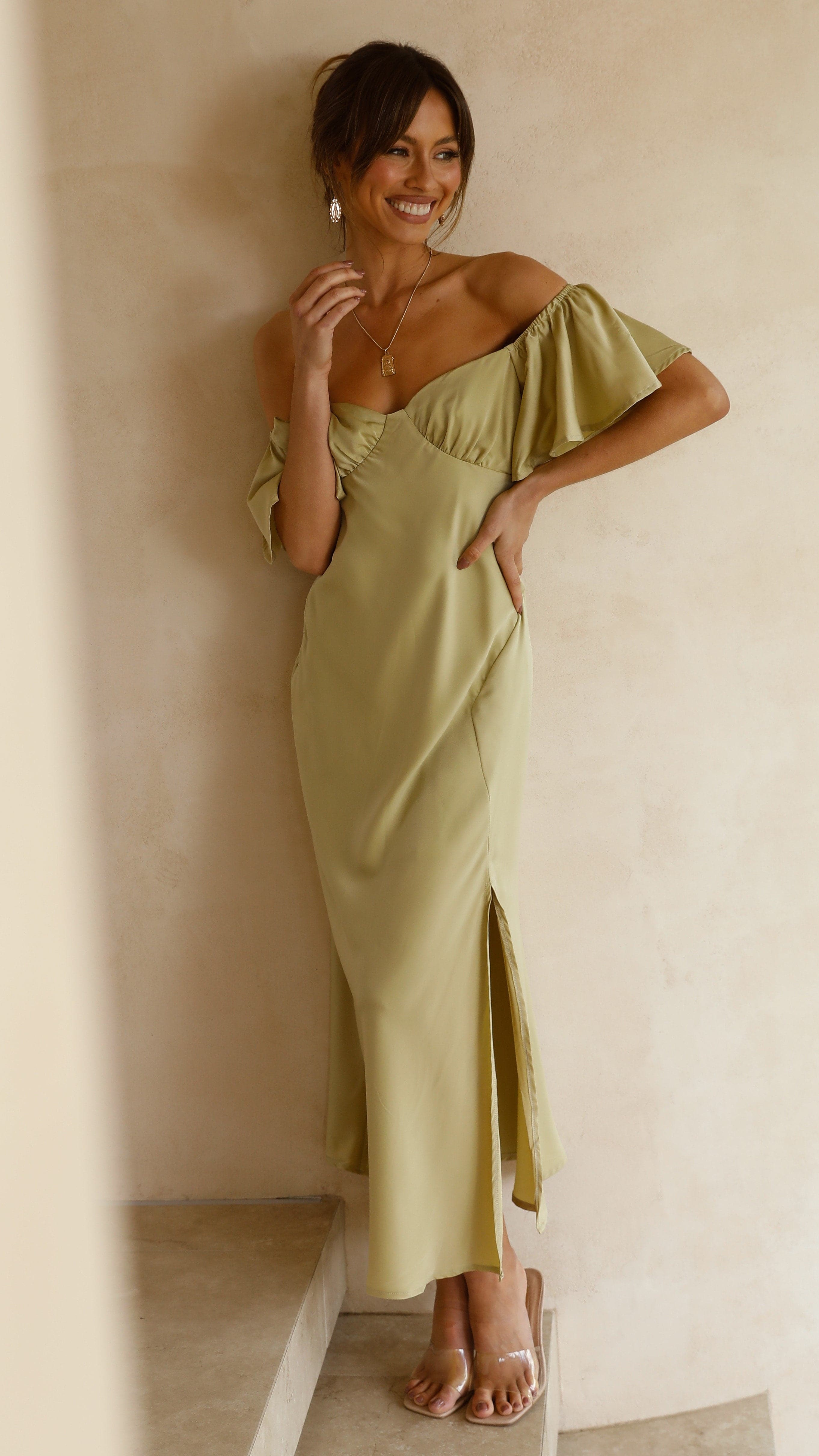 Cream ruffle midi dress with off-shoulder design and flutter sleeve detail side angle