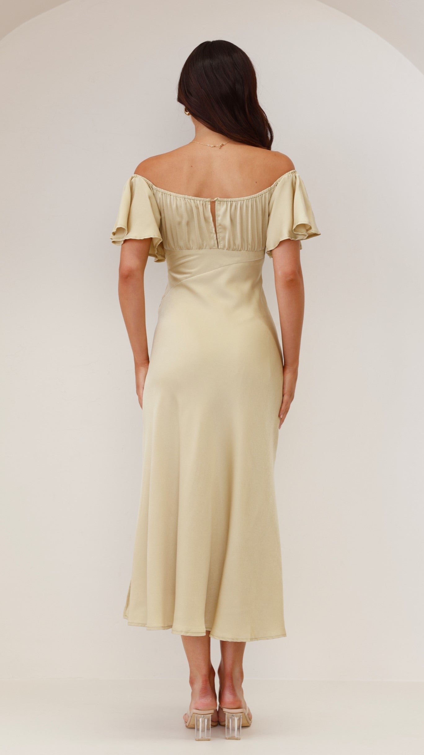 Back view of pale yellow ruffle midi dress showing gathered off-shoulder design