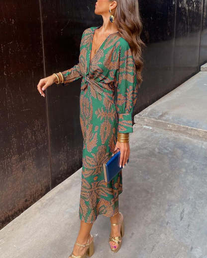 Green wrap midi dress with gold leaf print and long sleeves
