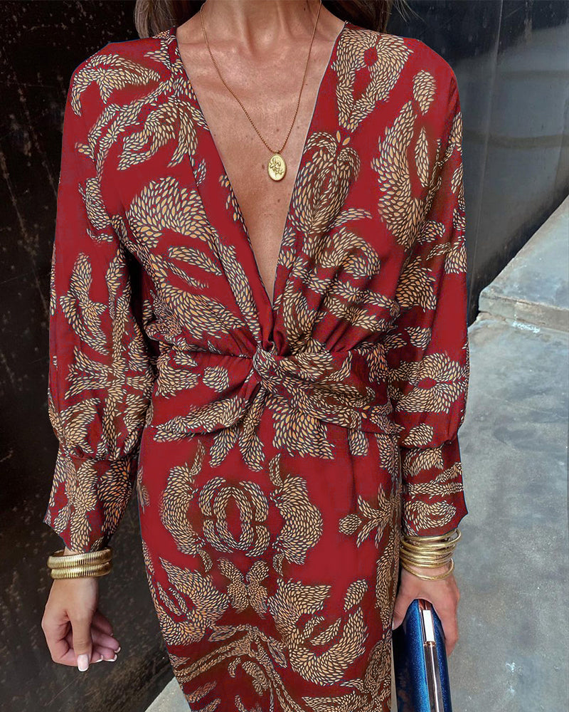 Front close-up of red wrap midi dress showing feather pattern and deep V-neckline