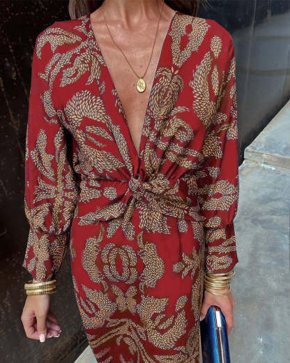 Front close-up of red wrap midi dress showing feather pattern and deep V-neckline