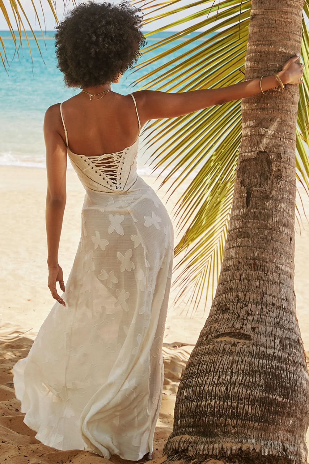 Cream lace maxi dress back view at beach with corset lacing