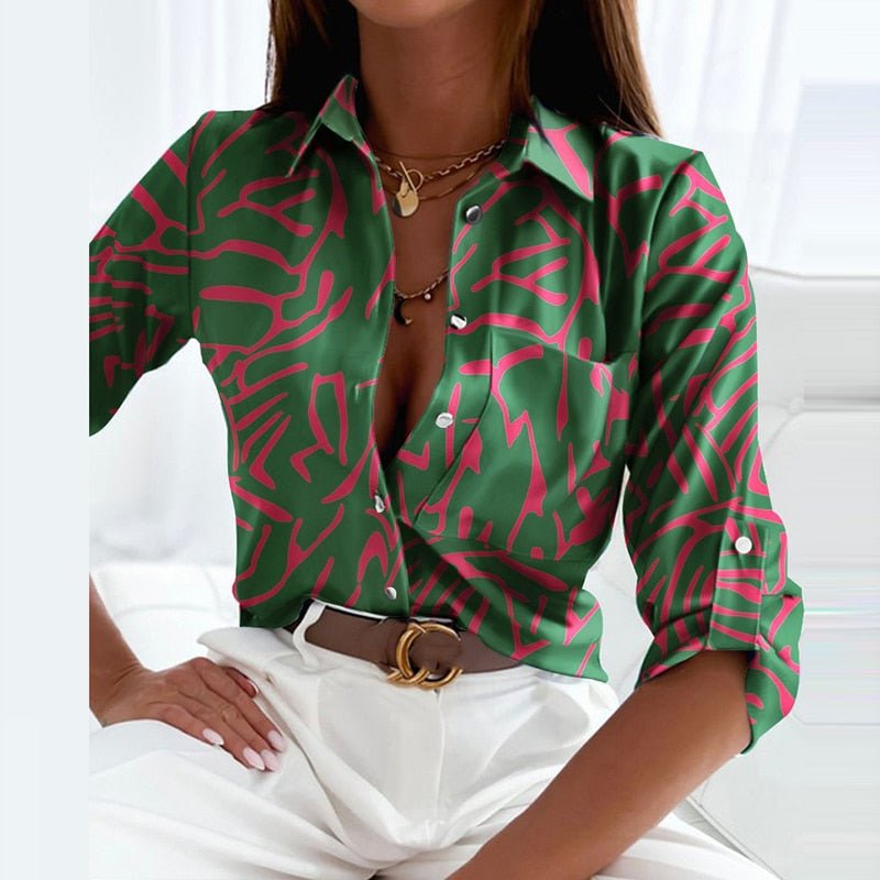 Green collared top with pink geometric line pattern and button front