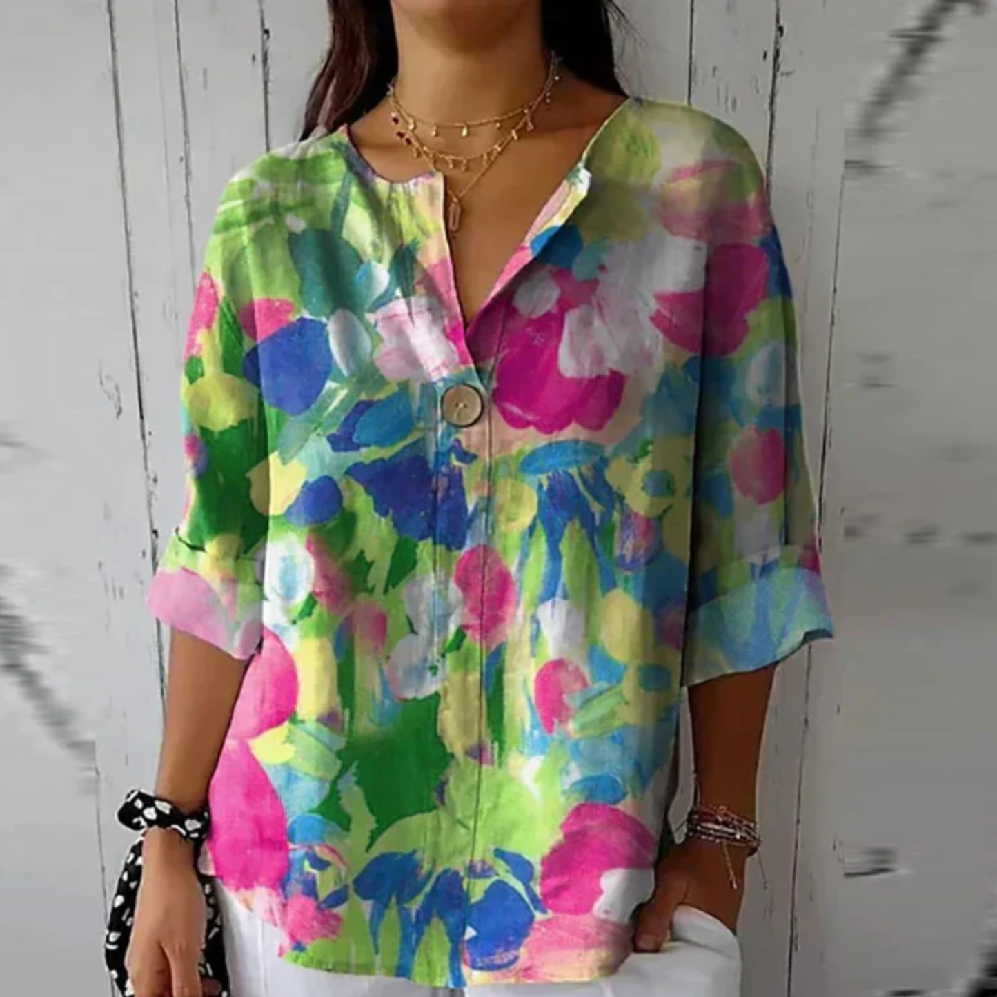 Vibrant lime and pink floral 3/4 sleeve top with bold watercolor flower design