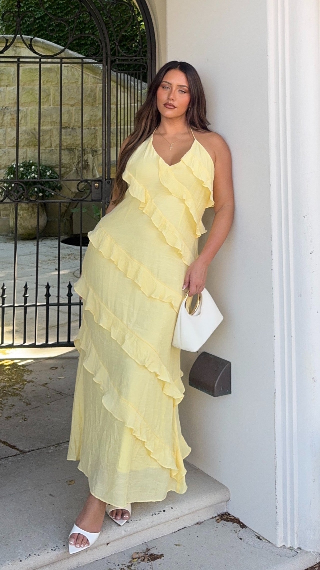 Pale yellow ruffled maxi dress with cascading ruffle layers