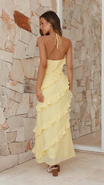 Back view of yellow halter maxi dress showing open back detail