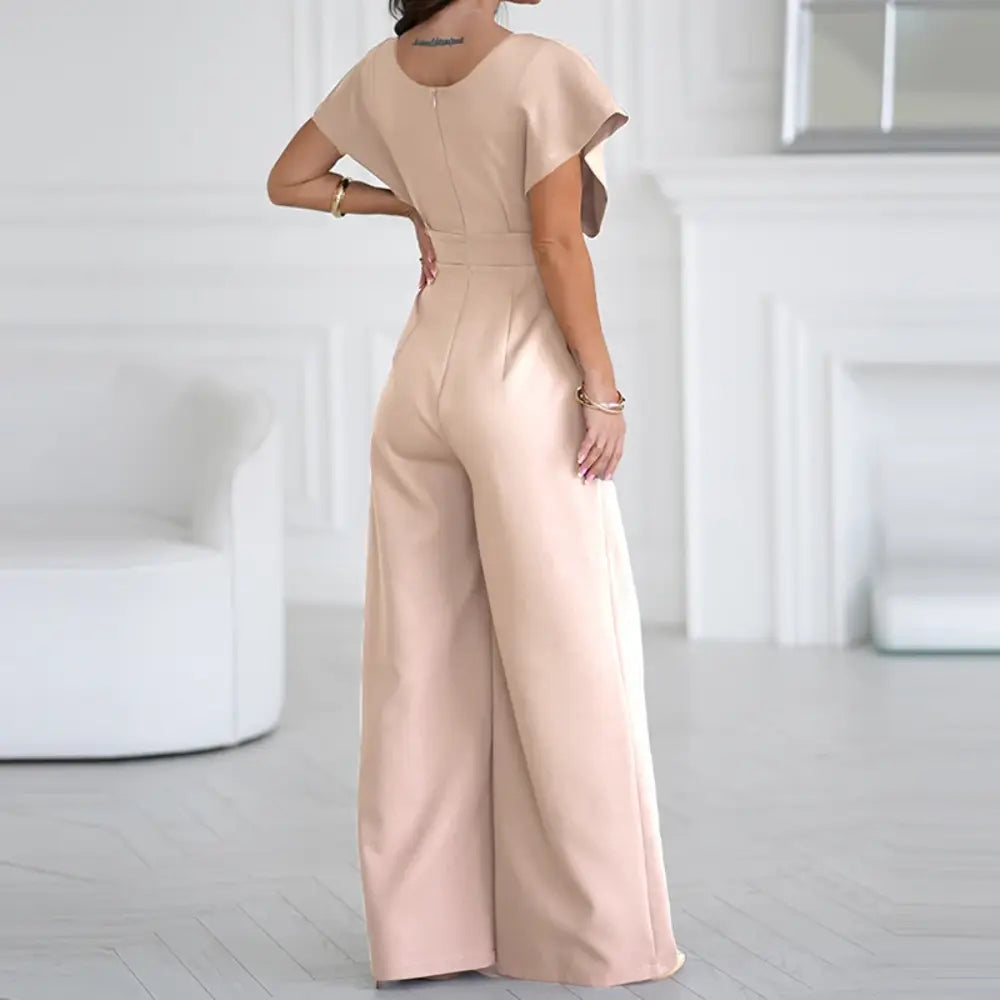 Blush pink wrap jumpsuit back view with short puffed sleeves