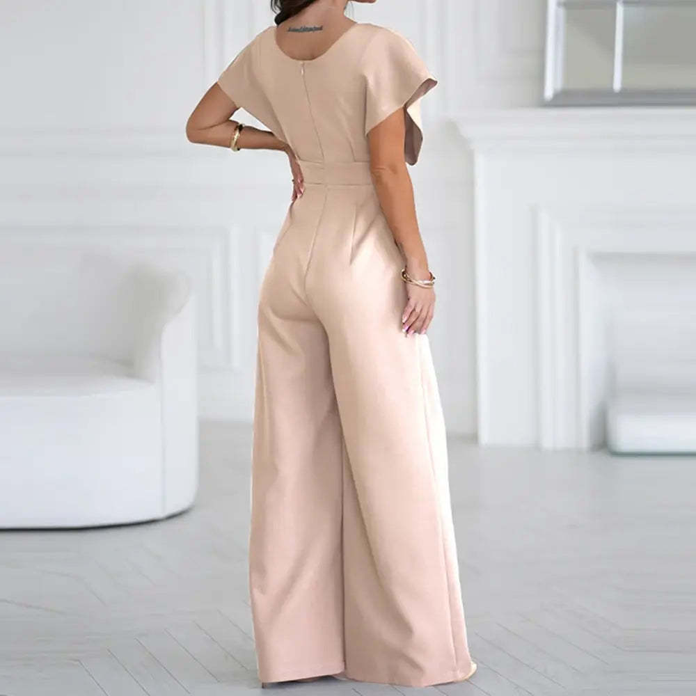 Blush pink wrap jumpsuit back view with short puffed sleeves