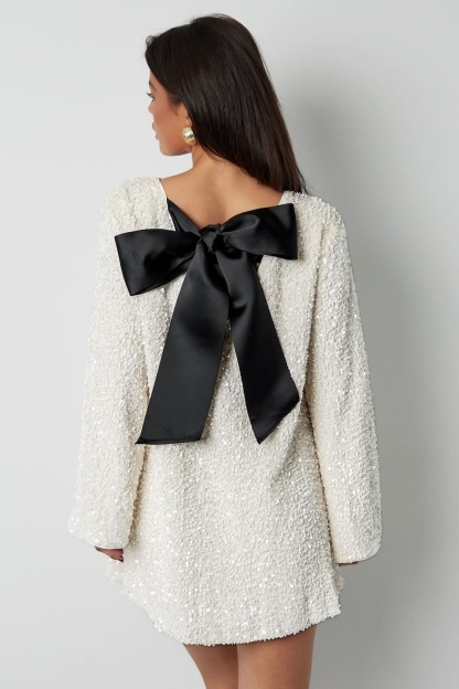 Cream textured mini dress with black bow detail on back