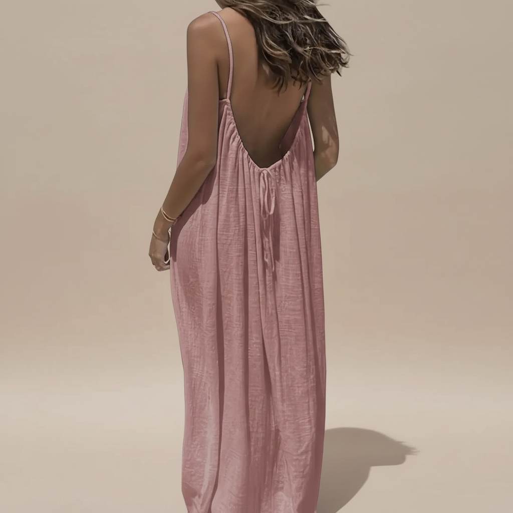 Back view of pink maxi dress showing deep V-back with drawstring detail and ruched fabric