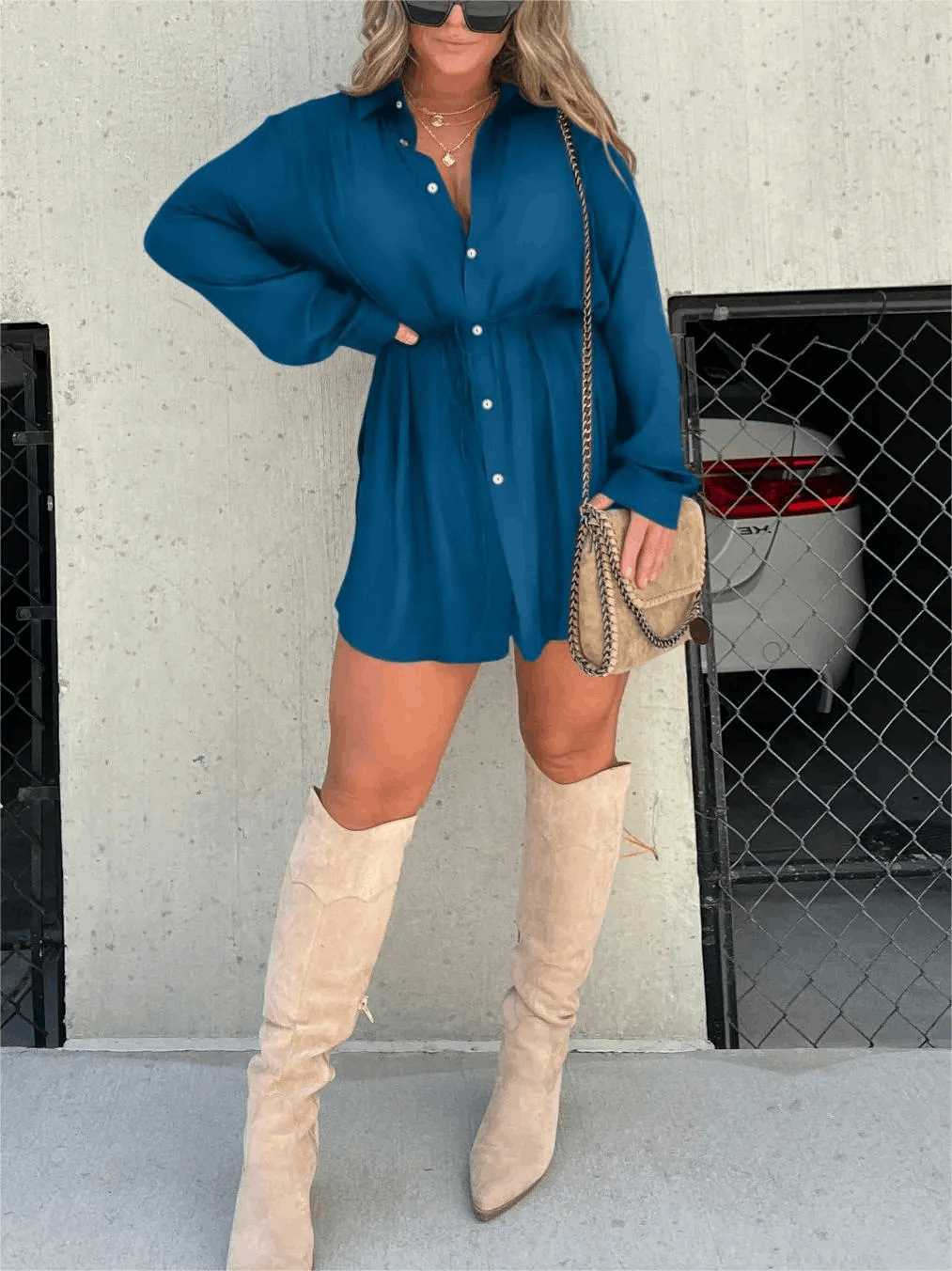Teal blue button-front mini romper with long sleeves and gathered waist