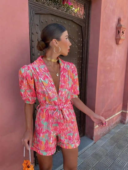 Side profile of pink wrap mini romper with short puffed sleeves