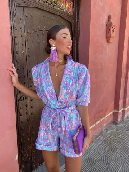 Front view of purple wrap romper with V-neckline and short sleeves