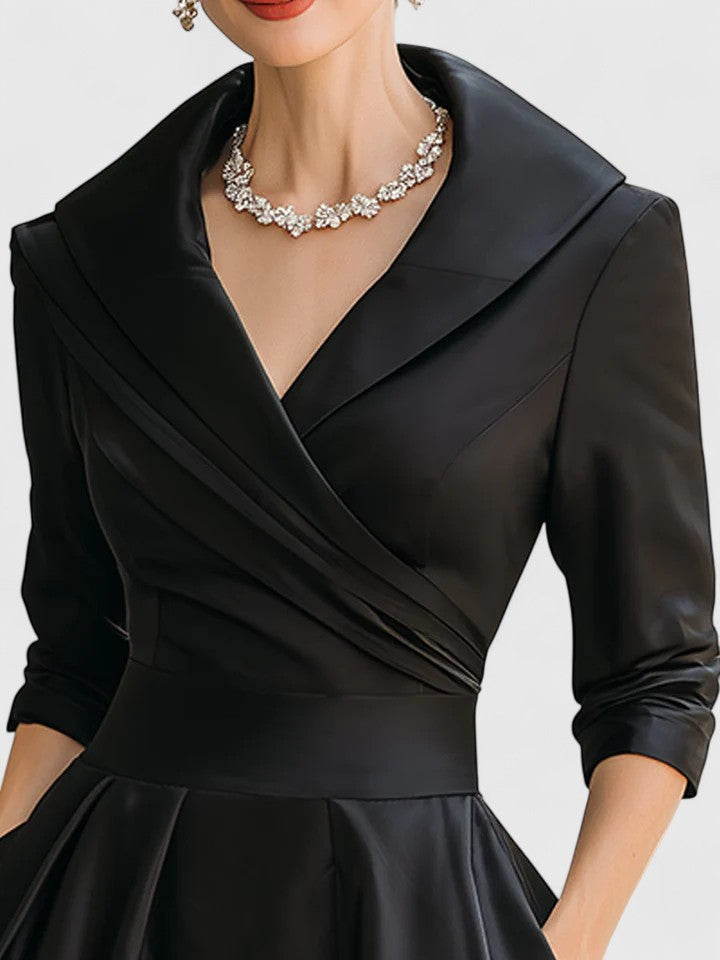 Close-up of black wrap midi dress neckline with notch collar detail