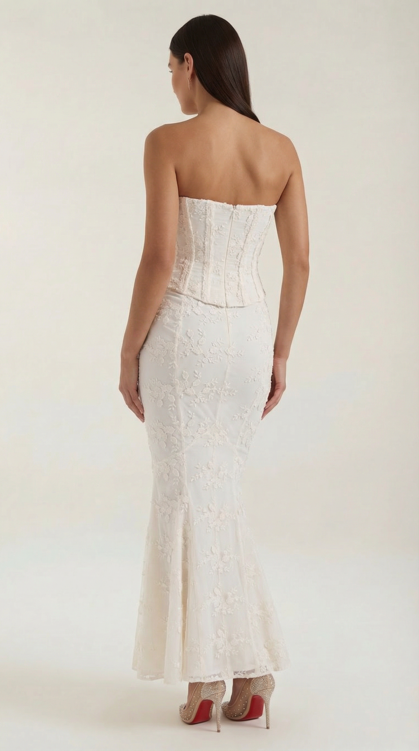 Back view of ivory strapless maxi dress showing corset construction and lace pattern