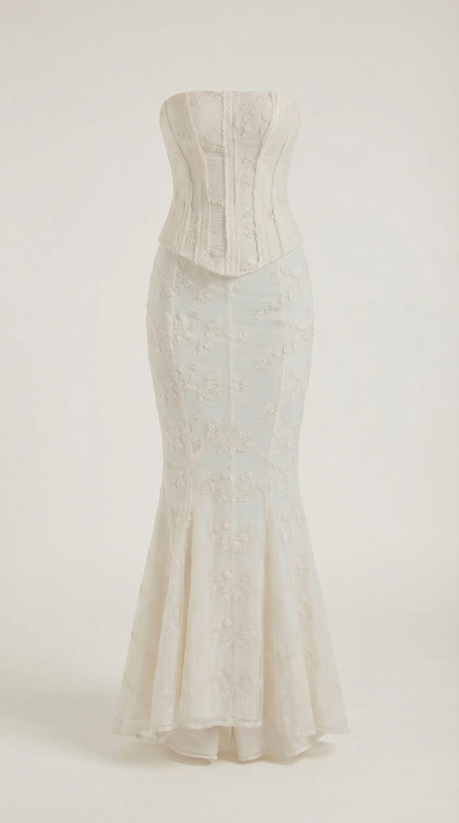 Full back angle of ivory corset maxi dress with dramatic mermaid flare and lace overlay
