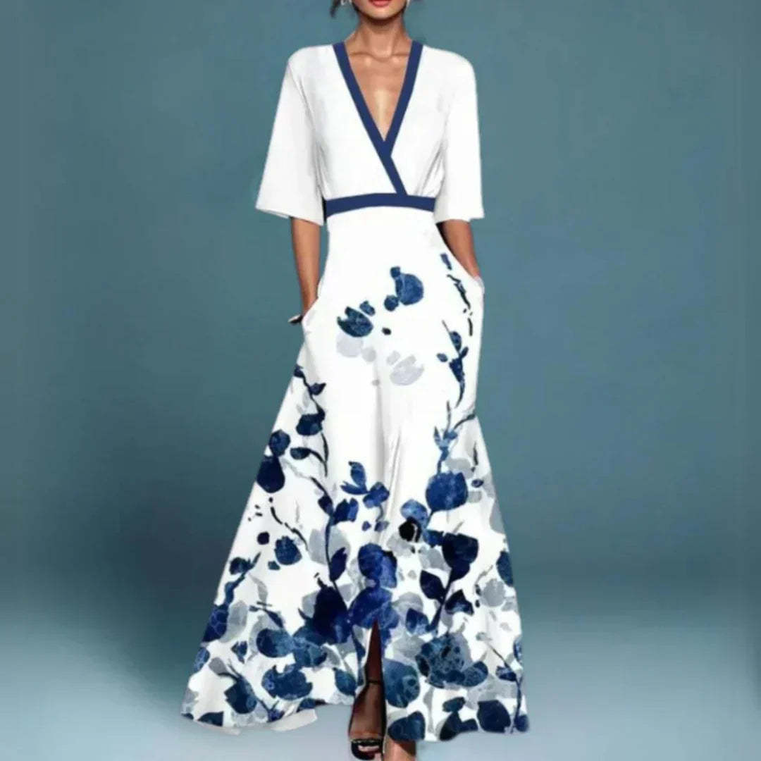 White maxi dress with navy blue floral print, wrap V-neck, and front slit detail