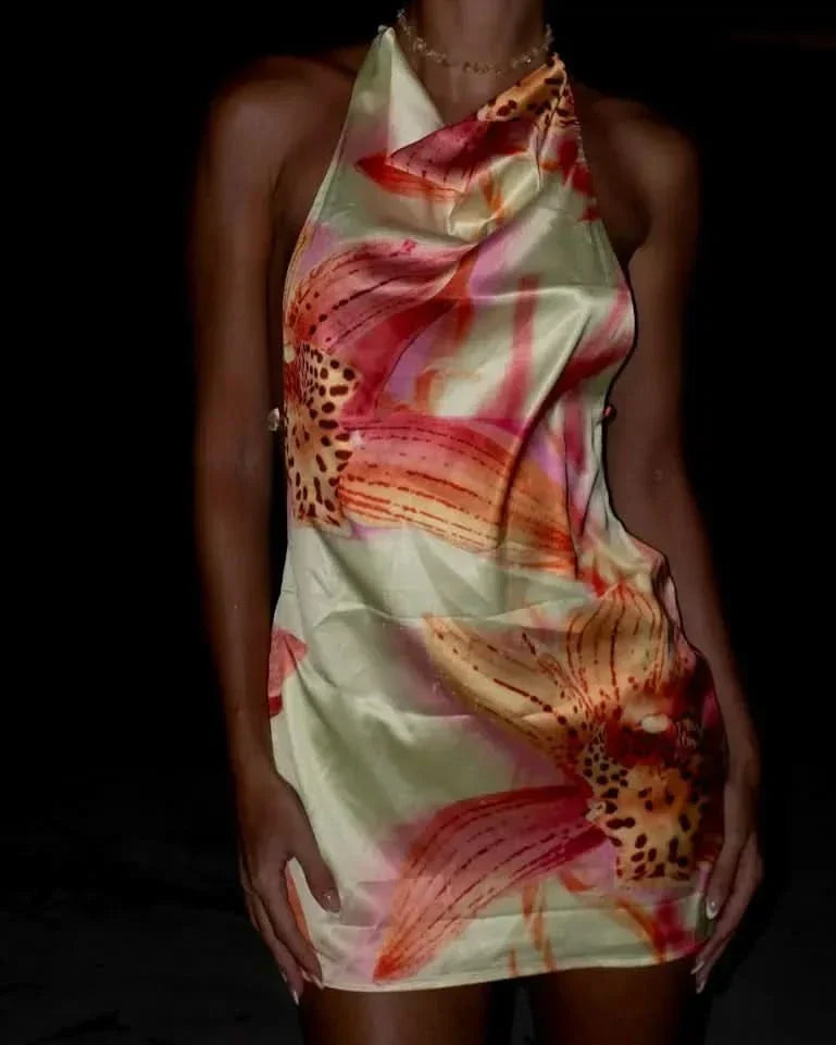 Close-up of cream halter mini dress featuring coral and pink botanical floral design