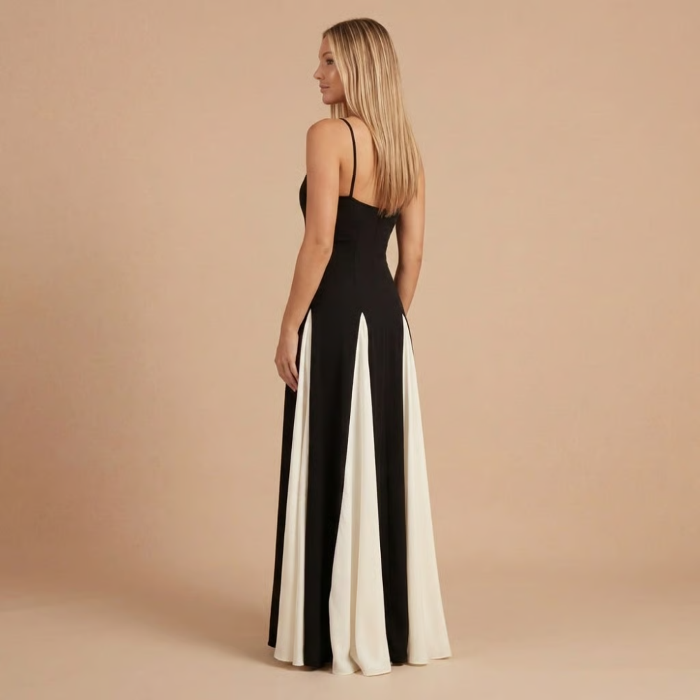 Back angle of colorblock maxi dress showing pleated white side panels and elegant drape