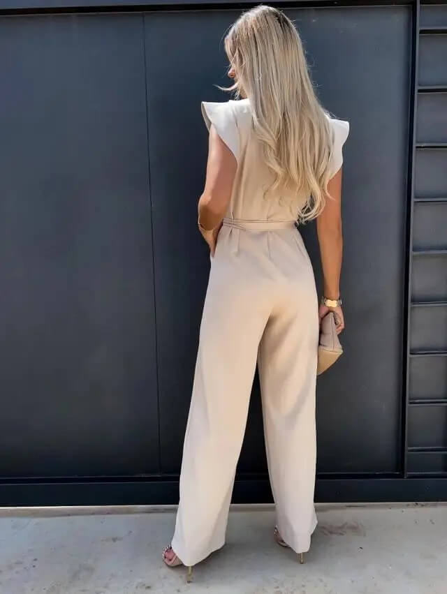 Back view of cream jumpsuit with ruffled cap sleeves and tie belt