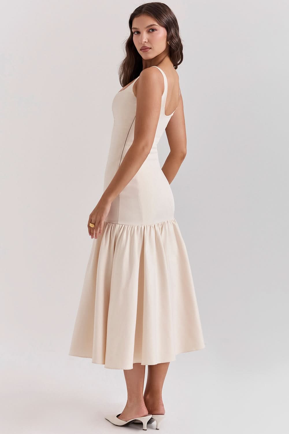 Cream ruffle midi dress back view with open scoop back and voluminous skirt