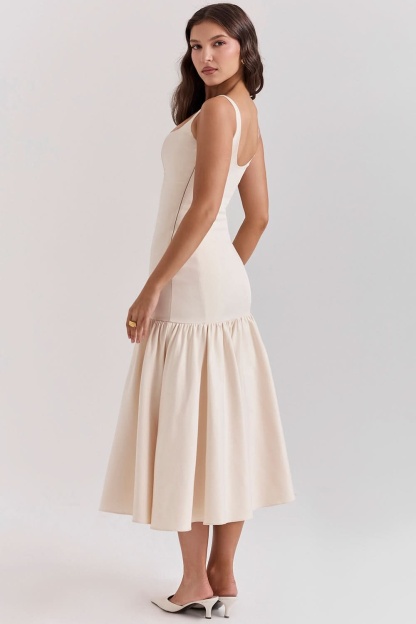 Cream ruffle midi dress back view with open scoop back and voluminous skirt