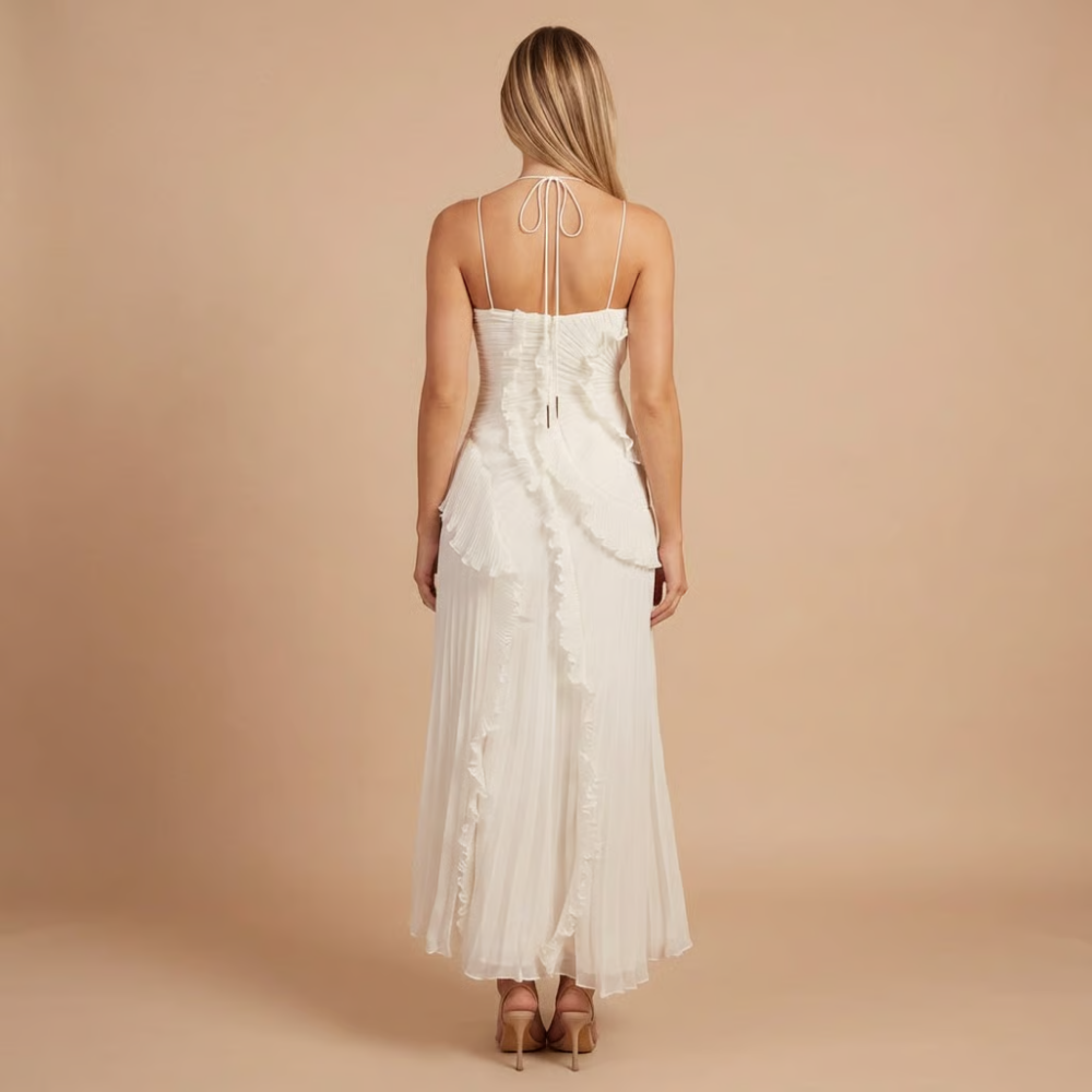 Back view of cream pleated midi dress with tie-back halter closure