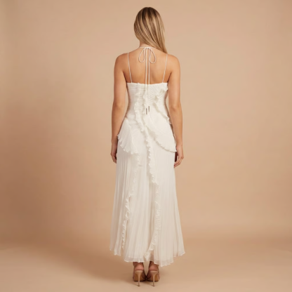 Back view of cream pleated midi dress with tie-back halter closure