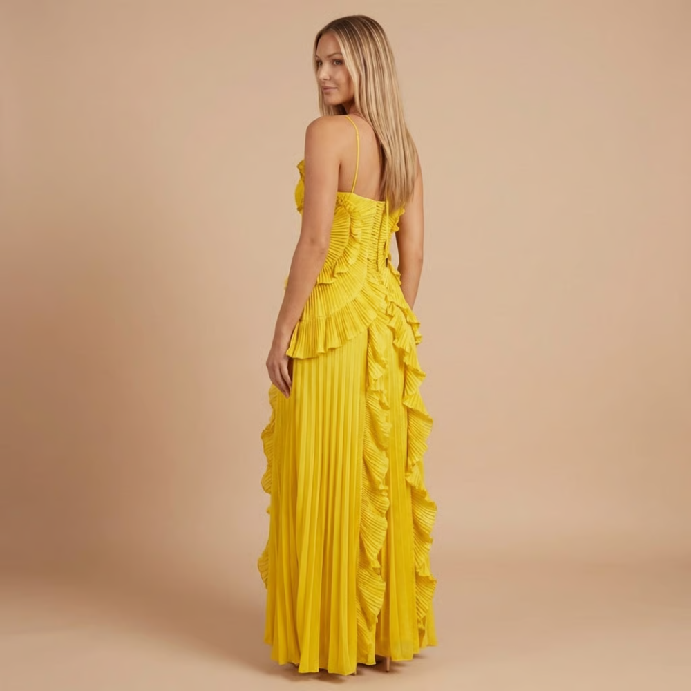 Back view of yellow pleated midi dress showing tie-back halter detail