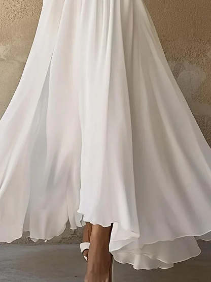 Ivory layered maxi dress hem with asymmetrical flowing layers