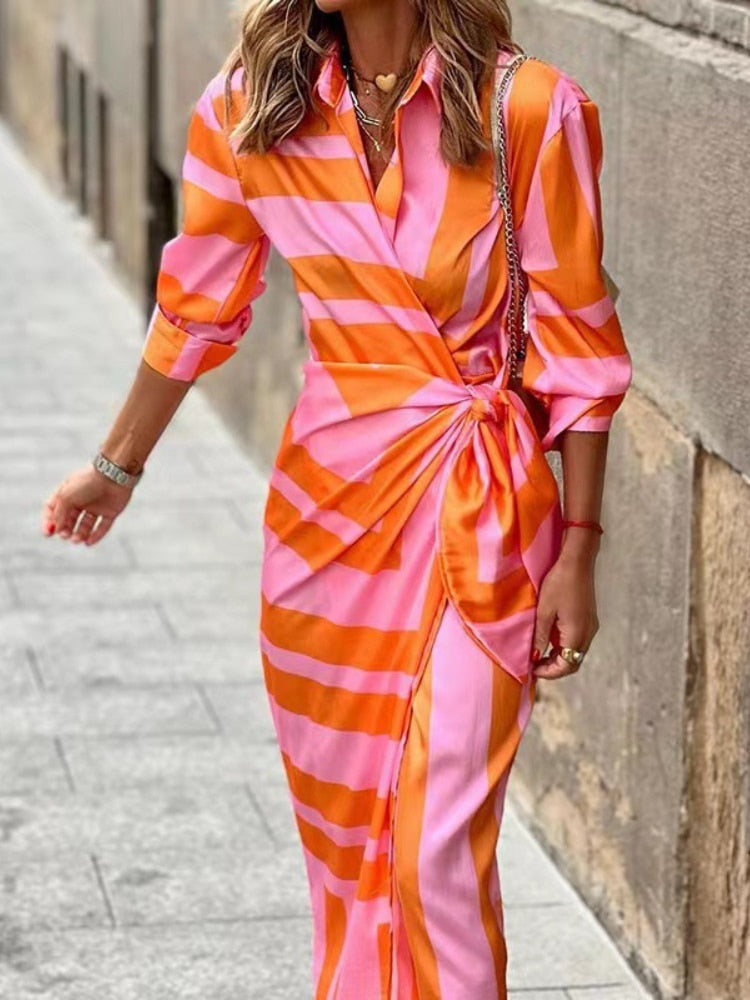 Pink and orange striped wrap midi dress with three-quarter sleeves and side tie detail