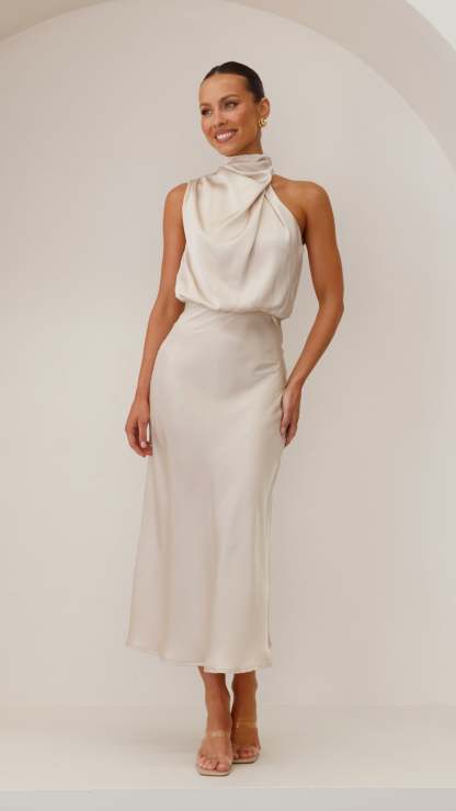 Cream draped halter midi dress with flowing neckline and fitted waist