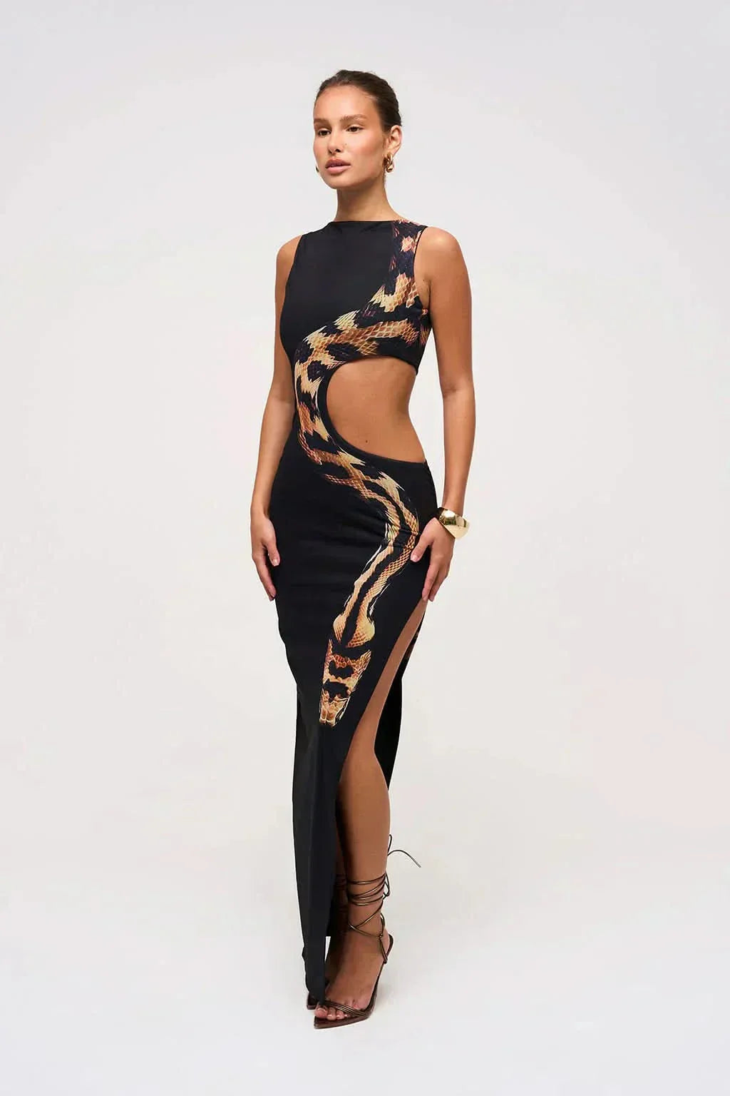 Black maxi dress featuring gold snake print design with high slit detail for women